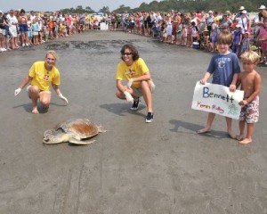 Willow, a sea turtle biologist, is pictured on the left helping with a sea turtle release